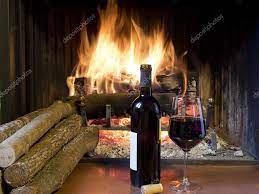A Glass Of Wine In Front Of A Fireplace