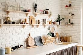 White Brick Wall And White Wooden Shelves