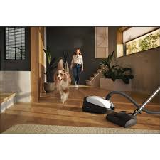 dog white canister vacuum cleaner