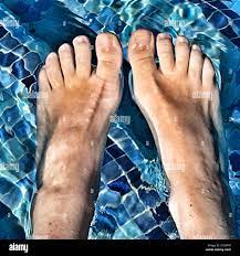 Summer fun. POV. Feet in swimming pool Stock Photo - Alamy