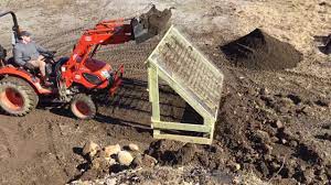 using a homemade topsoil screener with