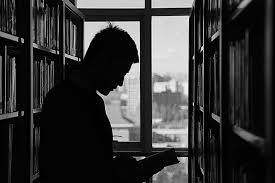 Image result for man looking at books in library
