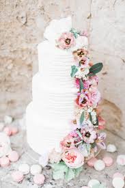 a wedding cake with fresh flowers