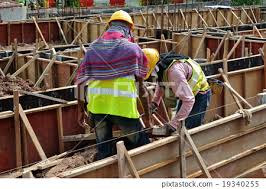 workers fabricating ground beam