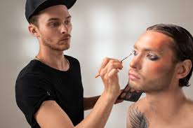 young makeup artist with brush or