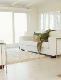 room that has white carpet white couches