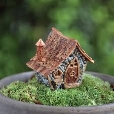 This fairy garden set comes with its very own magical fairy door, ladder, welcome mat, fairy dust, key, silver bucket, and watering can, mushroom table and chair, a fairy on the signpost, mushroom stick, garden lamp, fence, a bag of moss, decorative pebbles, glass pebble, dried pods, and twigs. Miniature Fairy Garden Micro Collection