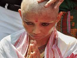 women shave their heads to protest