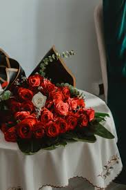 bouquet of red roses lying on a table