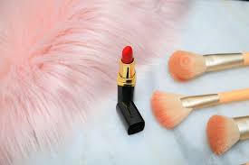 makeup brushes and lipsticks on the