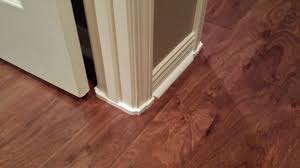 install wood flooring around door trim