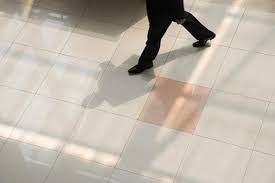 what causes floor tiles to lift
