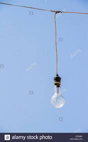 Light Bulb Hanging From Some Wires On A Blue Sky Stock Photo Alamy