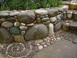 a retaining wall with river rocks