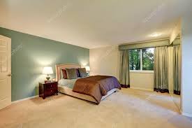 brown bedroom with beige carpet floor