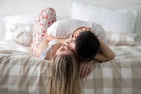hugging in bed stock photos royalty