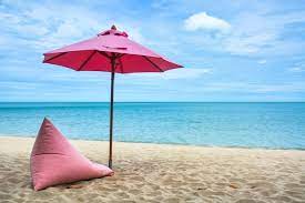 pink beach umbrella and a comfortable