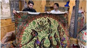 craftsman uses calligraphy on kashmiri