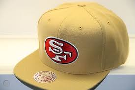 The 49ers' original logo was a mustached 49er gold miner from the 1849 california gold rush, dressed in plaid pants and a red shirt, jumping in midair with his hat falling off, and fired pistols in each hand: San Francisco 49ers Nfl Mitchell And Ness Snapback Cap Gold Hats Nz978 1098425598