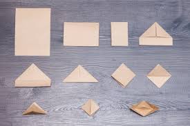 steps of making origami paper boat on