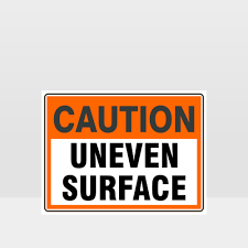 caution uneven surface sign caution