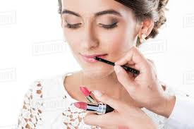 makeup artist applying lipstick