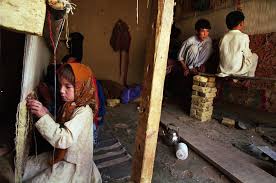 child labourer weaving carpets