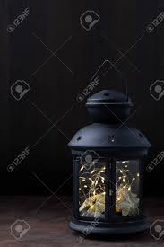 Fairy Lights Inside Vintage Lantern On Wooden Table