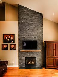 Dark Stone Veneer Fireplace With Wood