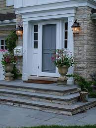 A welcoming front door and entryway provide both architectural interest and curb appeal to a home. Pin On Stone Walkway Ideas Slate
