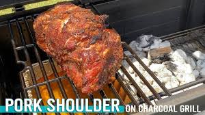 smoked pork shoulder on charcoal grill