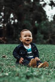 photo of smiling baby boy in denim
