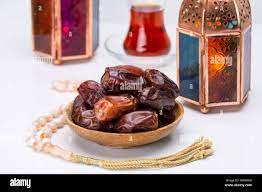 Ramadan Kareem Festive, close up of dates on wooden plate and rosary with  oriental Lantern lamps and cup of black tea on white background. Islamic  Hol Stock Photo - Alamy