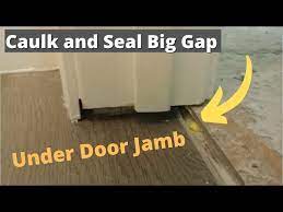 how to caulk a big gap under door jamb