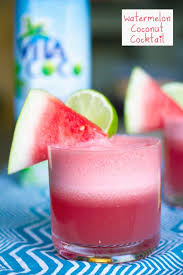 head on view of watermelon coconut l with watermelon wedge and lime garnish and carton