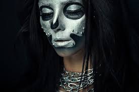 silver mask skull paint on dark wall