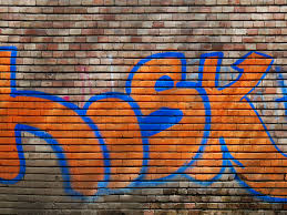 Orange Bricks Wall With Bright Graffiti