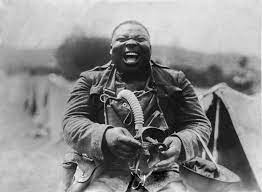 World War I soldier, identified as “Big Nims" of the 3rd Battalion, 366th Infantry, during gas mask drill, c. 1917 : r/OldSchoolCool