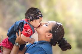 portrait of indian asian mother kissing