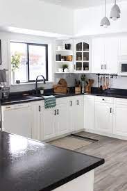 Here, it works well with the cloudy white cabinets, nickel pulls, stainless appliances and contrasting lighting hardware. Our Weekend Renovation A New Modern Kitchen Love Create Celebrate Black Countertops Modern Kitchen Kitchen Design