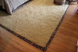 beige area rug with print border