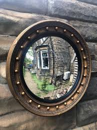 antique gilt framed convex wall mirror