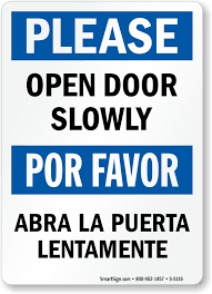 bilingual please open door slowly sign