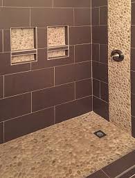 tan pebble tile shower floor with