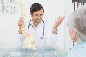 Male Doctor Explaining The Spine To A Senior Patient In Medical
