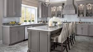A white kitchen hood with corbels stands over a white and grey marble brick tiled backsplash and a stainless steel stove lined with cutting boards. 34 Lovely Grey White Kitchen Design Ideas Magzhouse