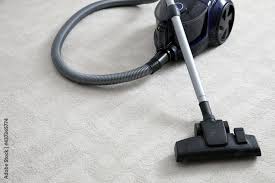 modern vacuum cleaner on carpet indoors