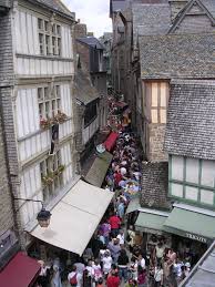 The cluster of historic structures built into the island's rising terrain attract visitors from across the globe. Mont St Michel Those Faraway Places