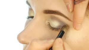 professional makeup artist applying eye