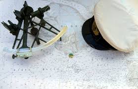 Sextant And Peaked Cap On A Chart